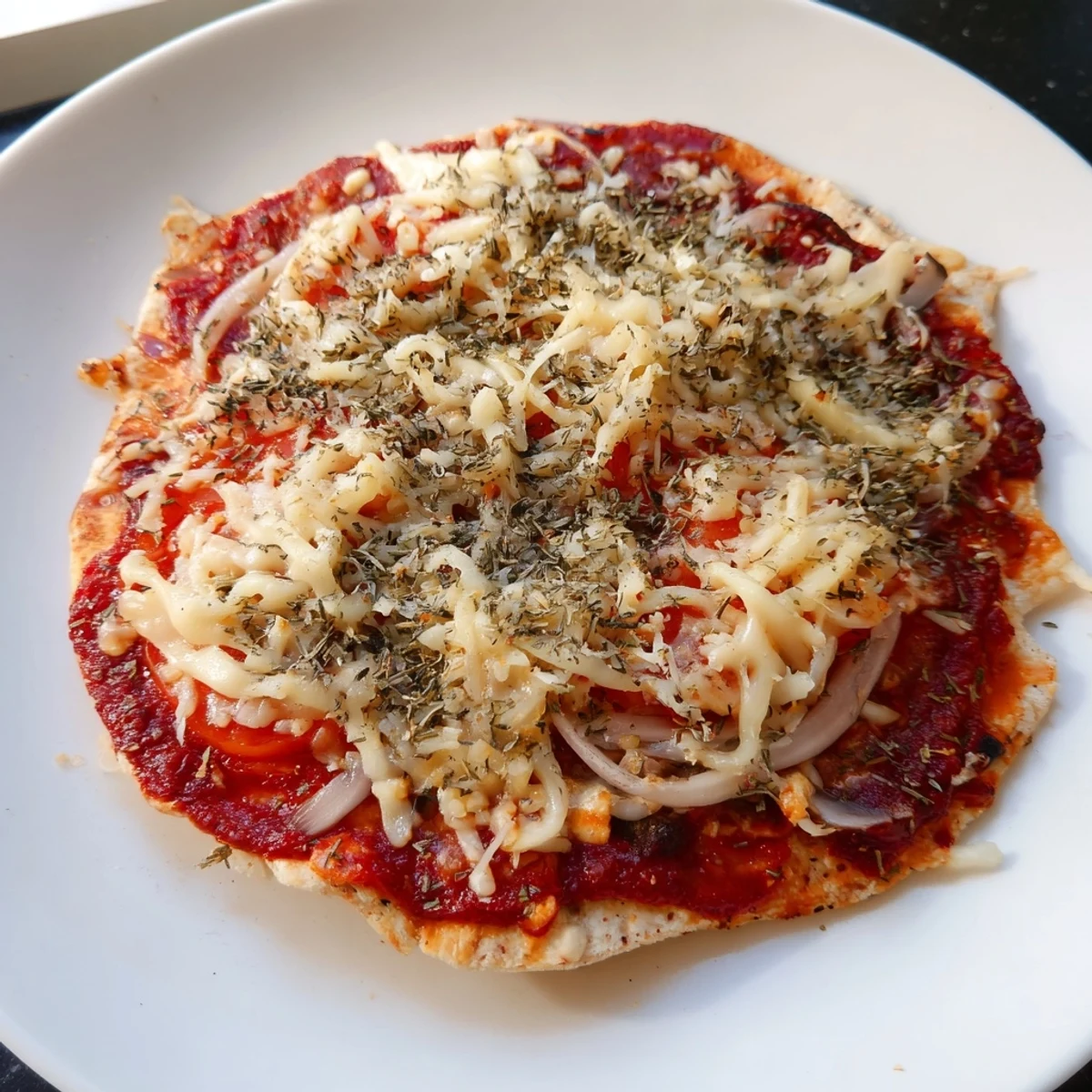 A close-up shot of homemade flatbread pizza, showcasing melted cheese and vibrant, affordable toppings.