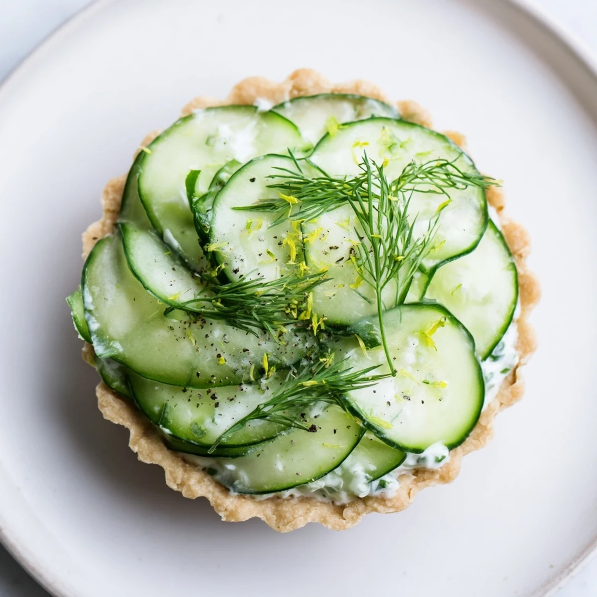 Fresh, creamy Simplified Mizeria Tartlets, with vibrant cucumbers and dill, perfect for a summer appetizer.