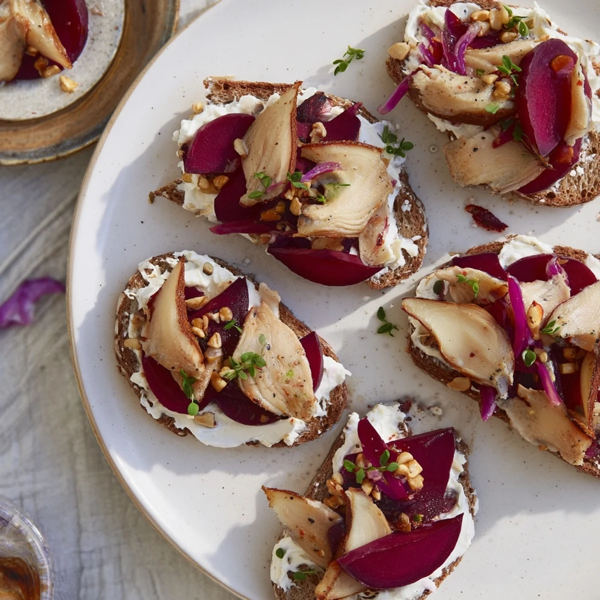 Close-up of a Scandinavian Express Herring & Beet Tartine, ready to eat with fresh dill and capers.