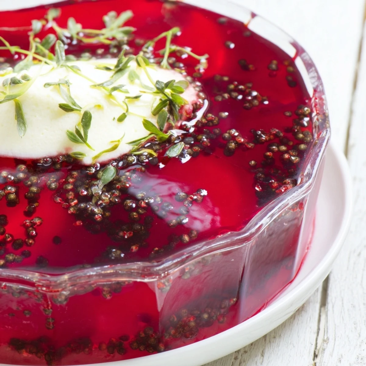 Vibrant Simplified Barszcz Spiced Jelly, chilled and topped with a creamy dollop of fresh dill.