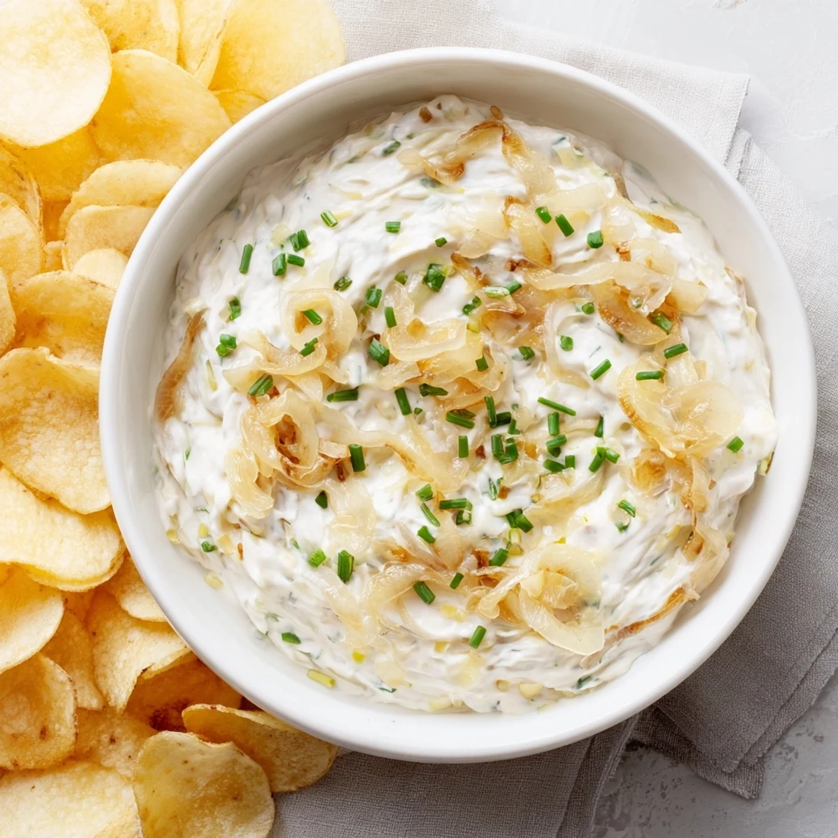 Fresh chives and a perfect pairing: salty potato chips and rich, flavorful onion dip.