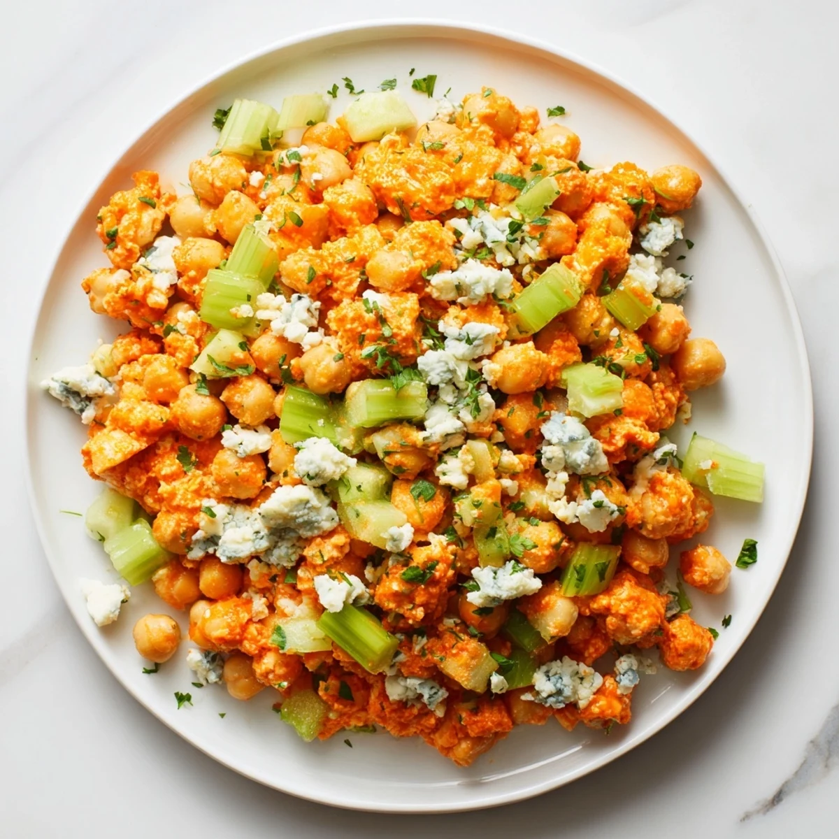 Buffalo chicken bean salad with vibrant vegetables and creamy blue cheese crumbles.
