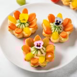 These whimsical fairy garden flower shaped snacks feature cheerful carrot and pepper decorations.