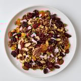 Golden-hued Mélange Hivernal Flocon de Neige, featuring dried fruits and nuts, perfect for holiday gatherings.