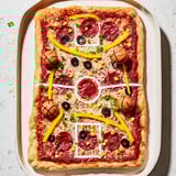 A playful, crowd-pleasing pizza designed to look like a basketball court, complete with fun free throw topping shots. Perfect for sports parties or family nights.