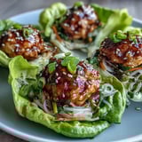 Fresh ginger, garlic, and sesame in the savory sauce fill these Potsticker Noodle Lettuce Cups with turkey noodles for an easy weeknight bite.