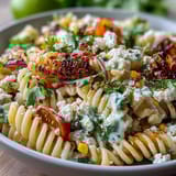 1. Creamy Mexican street corn elote pasta salad with charred corn, cotija cheese, and zesty lime dressing, perfect for summer gatherings.  