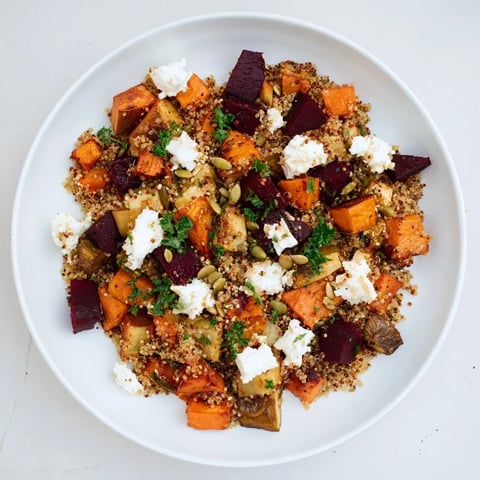 Warm Quinoa and Roasted Root Vegetable Salad with feta, colorful and flavorful, served in a bowl.