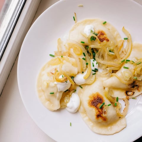 Golden-brown Authentic Potato and Cheese Pierogi Ruskie, a comforting Polish dumpling dish, ready to savor.