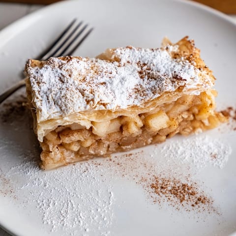 Crispy, flaky Apple Cinnamon Chruściki recipe, showcasing filled centers; fried treat popular with coffee.