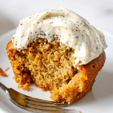 Golden-brown pumpkin muffins topped with decadent cream cheese and poppy seed frosting.  