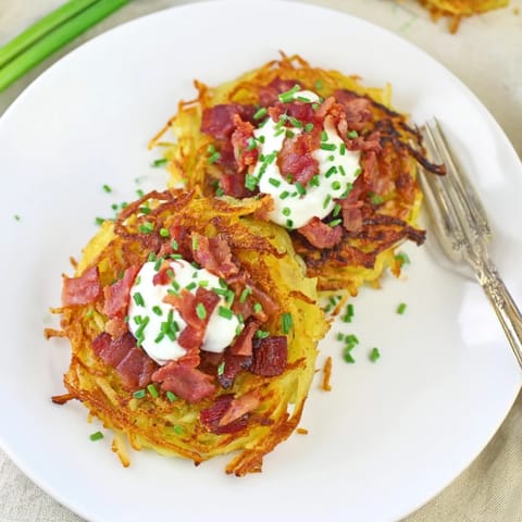 Golden potato pancakes topped with smoky bacon and tangy sour cream delight.  