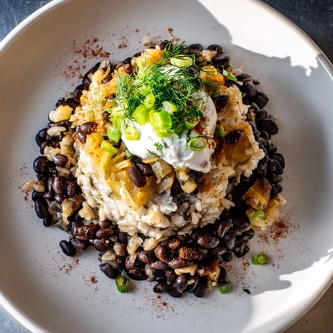 Close-up of a vibrant rice & beans burrito bowl with creamy potato filling and fresh dill sprinkles.