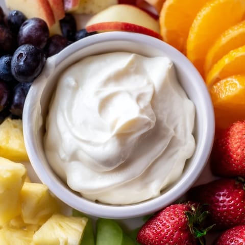 Sweet cream cheese fruit dip centerpiece, ready to dip refreshing strawberries and melon.