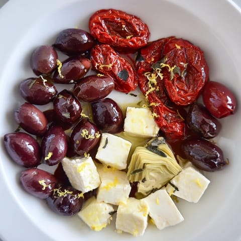 Vibrant image shows a Black Olive and Sun-Dried Tomato Platter ready for a New Year's Eve party.