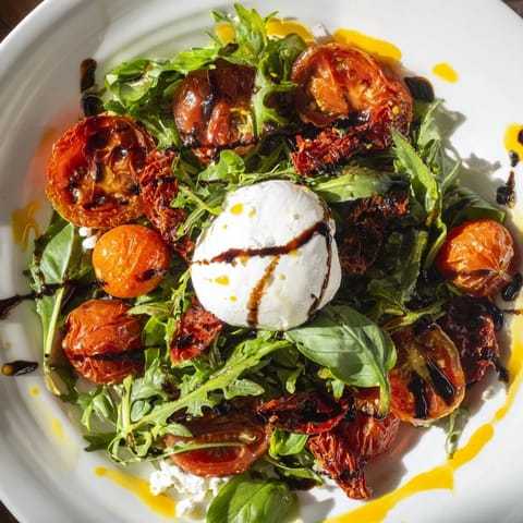 Fresh Tomato Flight Salad displaying sun-dried tomatoes, fresh basil, and a luscious balsamic glaze.