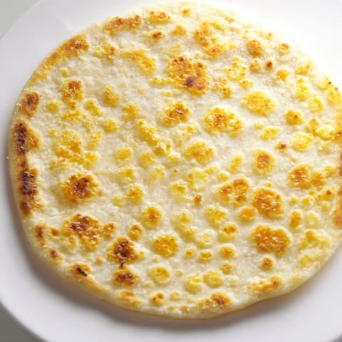 A stack of fluffy cottage cheese flatbread, perfect for dipping or enjoying as a wrap.
