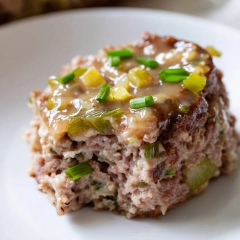 Warm, tender mini meatloaf bites, baked golden brown with a savory glaze for sharing.