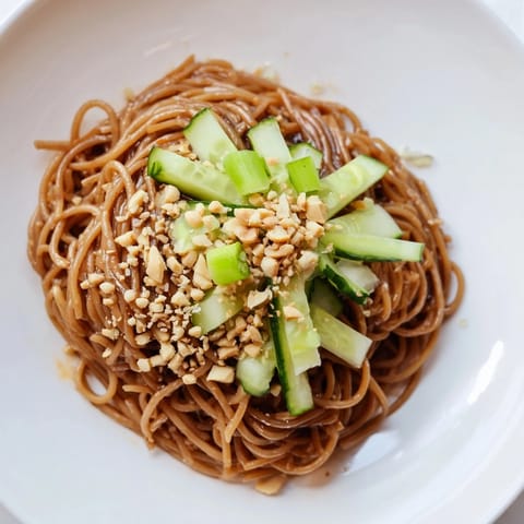 Fresh Spicy Sesame Noodle Salad with vibrant cucumber ribbons and fragrant cilantro, a quick meal.