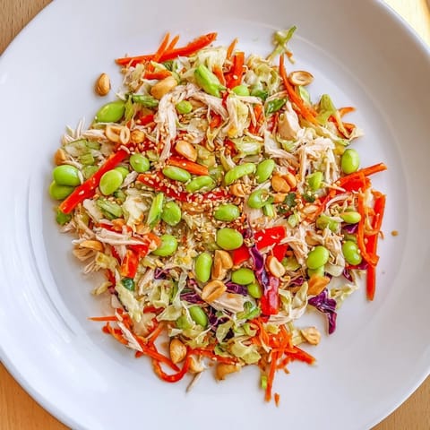 This Edamame Crunch Chicken Salad features shredded chicken, crunchy cabbage, and a flavorful ginger dressing.