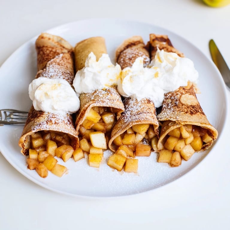 Golden brown Mini Apple Nalesniki recipe: Polish crepes, dusted with powdery sugar served warm.