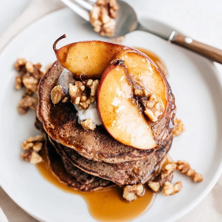 Imagine fluffy buckwheat pancakes, spiced roasted apples, and walnuts – a delectable autumn treat.