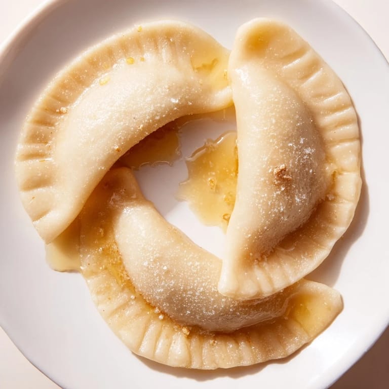 Taste the simplicity: warm 3-ingredient sweet pierogi dusted with powdered sugar, a perfect dessert.
