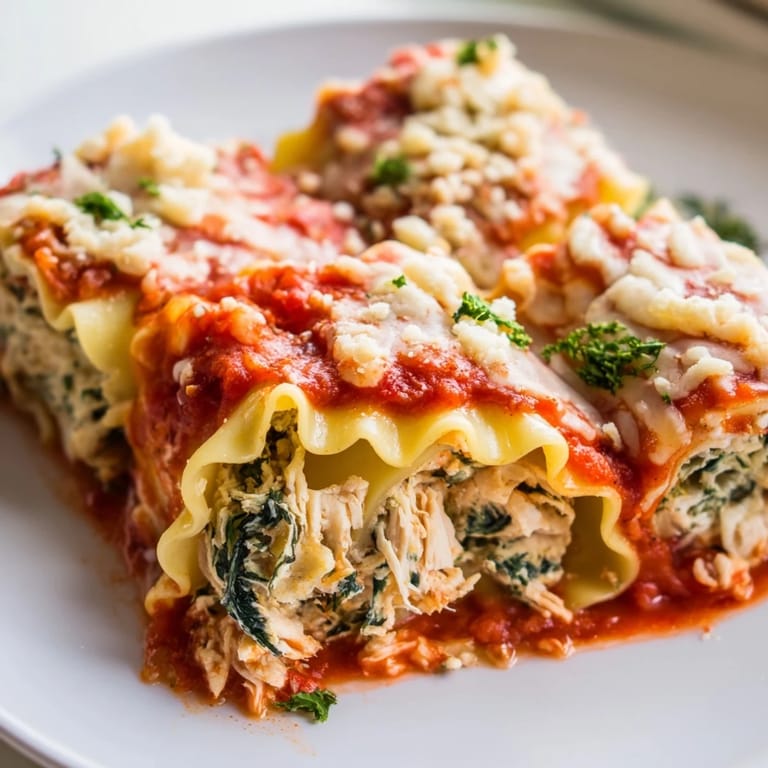 Golden-brown Chicken and Spinach Lasagna Rolls, stuffed with a cheesy filling, ready for a delicious dinner.